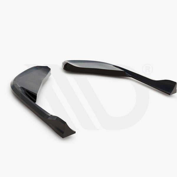 Two sleek, curved black aerodynamic components are positioned on a white surface. Below, text reads: "WORLDWIDE LEADER IN AERODYNAMIC COMPONENTS."