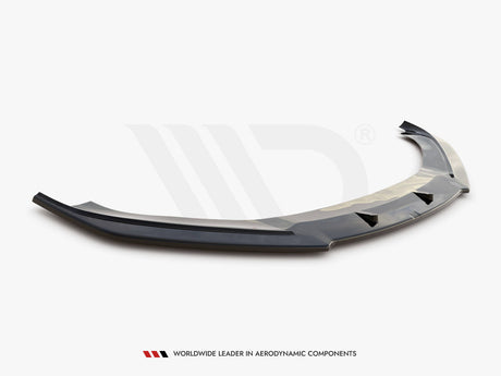 A glossy black car front splitter with aerodynamic fins rests on a white surface. Text reads: "WORLDWIDE LEADER IN AERODYNAMIC COMPONENTS."