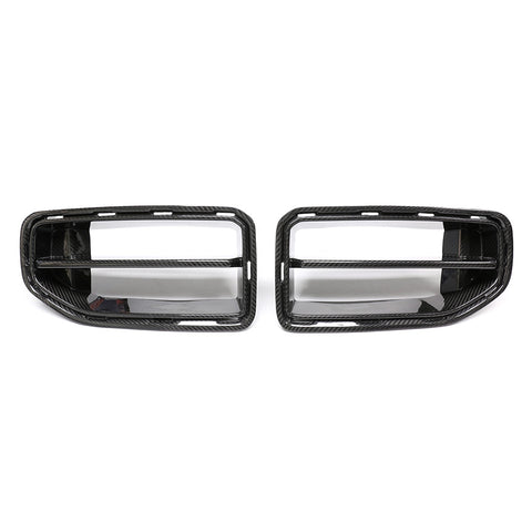Two carbon fiber car grilles are placed side by side against a white background. Each grille features horizontal slats and a textured finish, indicative of automotive parts.