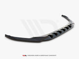 Curved black car spoiler resting on a plain white background. It features angular design elements for aerodynamic enhancement. Text reads: 