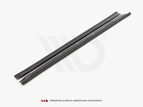 Two sleek, black side skirts lie parallel on a white background. Text below reads: "WORLDWIDE LEADER IN AERODYNAMIC COMPONENTS."