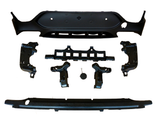 Various black plastic car bumper components are arranged on a white background, including a large panel, brackets, and a cover. The parts appear organized, showcasing individual pieces.