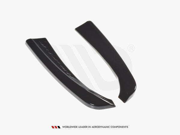 Two sleek, black curved aerodynamic components lie on a white surface. Text below reads: "WORLDWIDE LEADER IN AERODYNAMIC COMPONENTS."