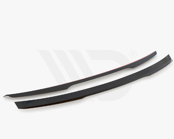 Two sleek black aerodynamic components are displayed on a white background. They are thin, elongated, and slightly curved. Text below reads, "WORLDWIDE LEADER IN AERODYNAMIC COMPONENTS."