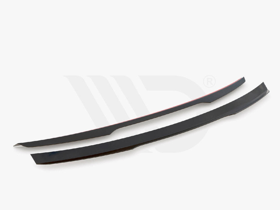Two sleek black aerodynamic components are displayed on a white background. They are thin, elongated, and slightly curved. Text below reads, "WORLDWIDE LEADER IN AERODYNAMIC COMPONENTS."