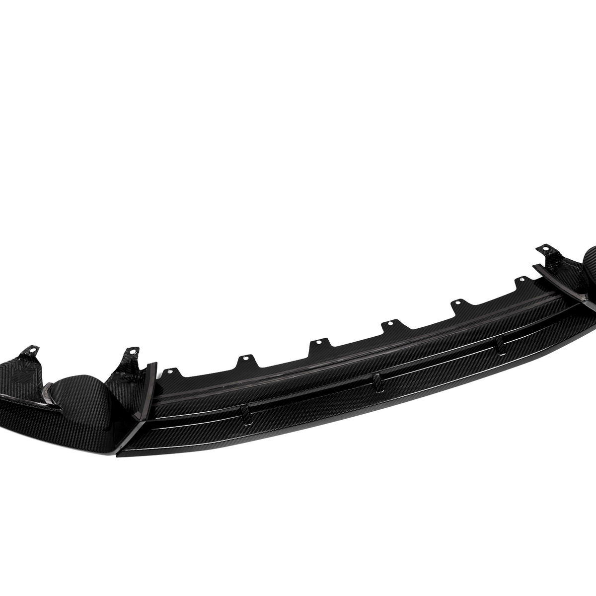 A glossy, carbon fiber car bumper lip is shown from the front, detached and isolated on a white background, highlighting its aerodynamic design and mounting features.