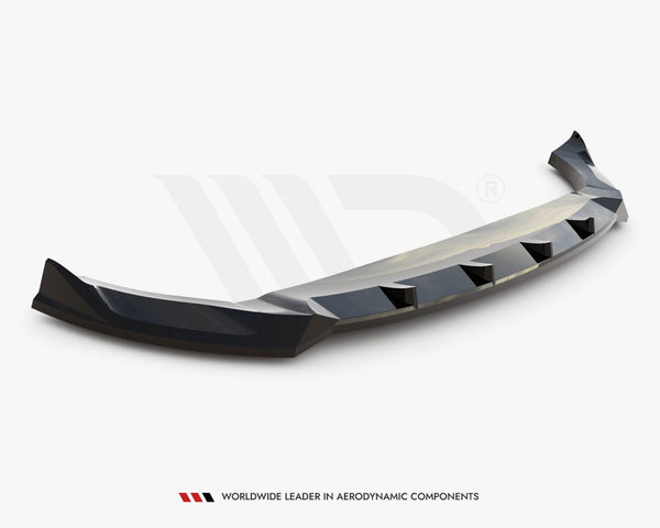 A black car bumper lip spoiler, angled with aerodynamic features, rests on a plain white background. Text reads “WORLDWIDE LEADER IN AERODYNAMIC COMPONENTS.”