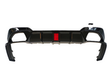A black car bumper with an integrated red reflector in the center is displayed against a white background, featuring aerodynamic contours and bracket extensions.