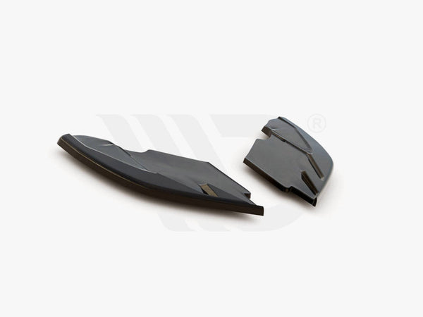 Two black aerodynamic components rest on a white surface, showcasing their sleek, angular design. Text below reads: "WORLDWIDE LEADER IN AERODYNAMIC COMPONENTS."