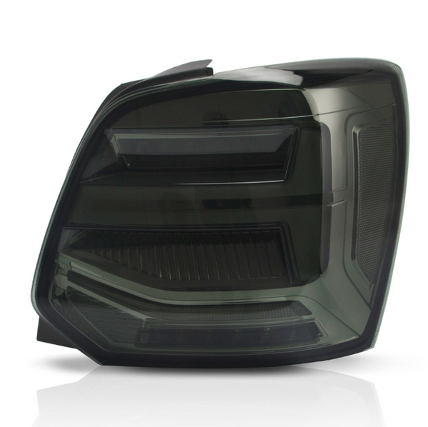 A dark-tinted vehicle taillight with angular, horizontal light strips and reflective surfaces against a plain white background.