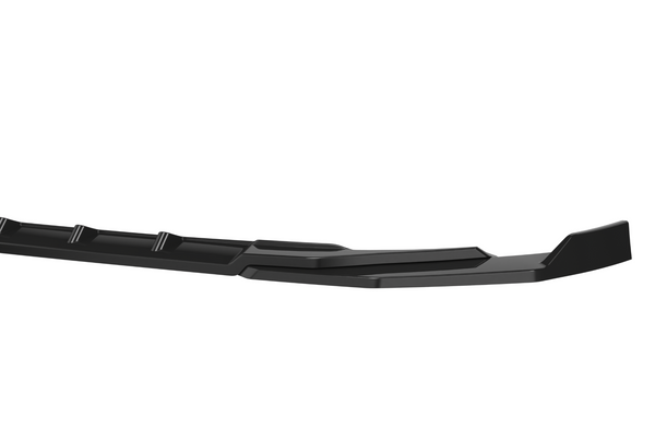 A long, black, contoured car bumper is positioned horizontally against a plain white background, showing its streamlined design and subtle surface details.