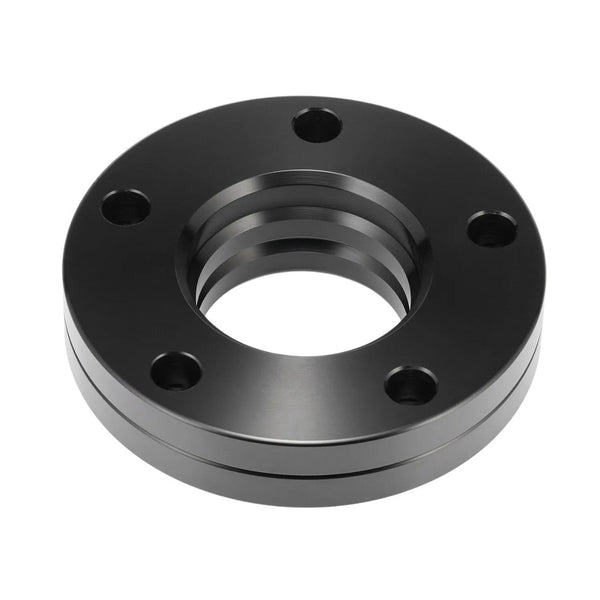 A black, circular metal flange with five bolt holes and a threaded central opening, rests in a white background, suggesting functionality in industrial or mechanical settings.