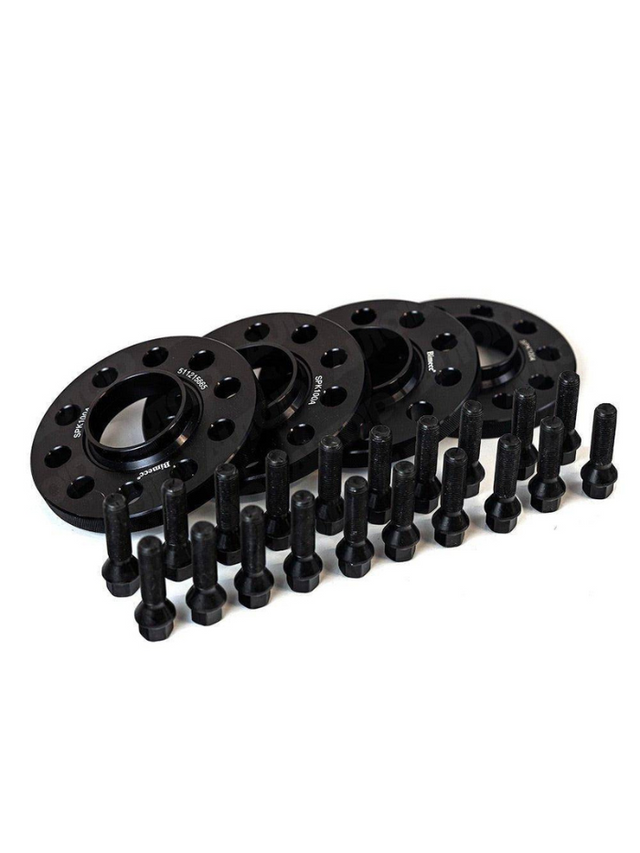 Black wheel spacers are arranged neatly, accompanied by multiple bolts aligned in front. The context is a plain white background. Some spacers display text: "S7-10-5885," "S90-160 4A."