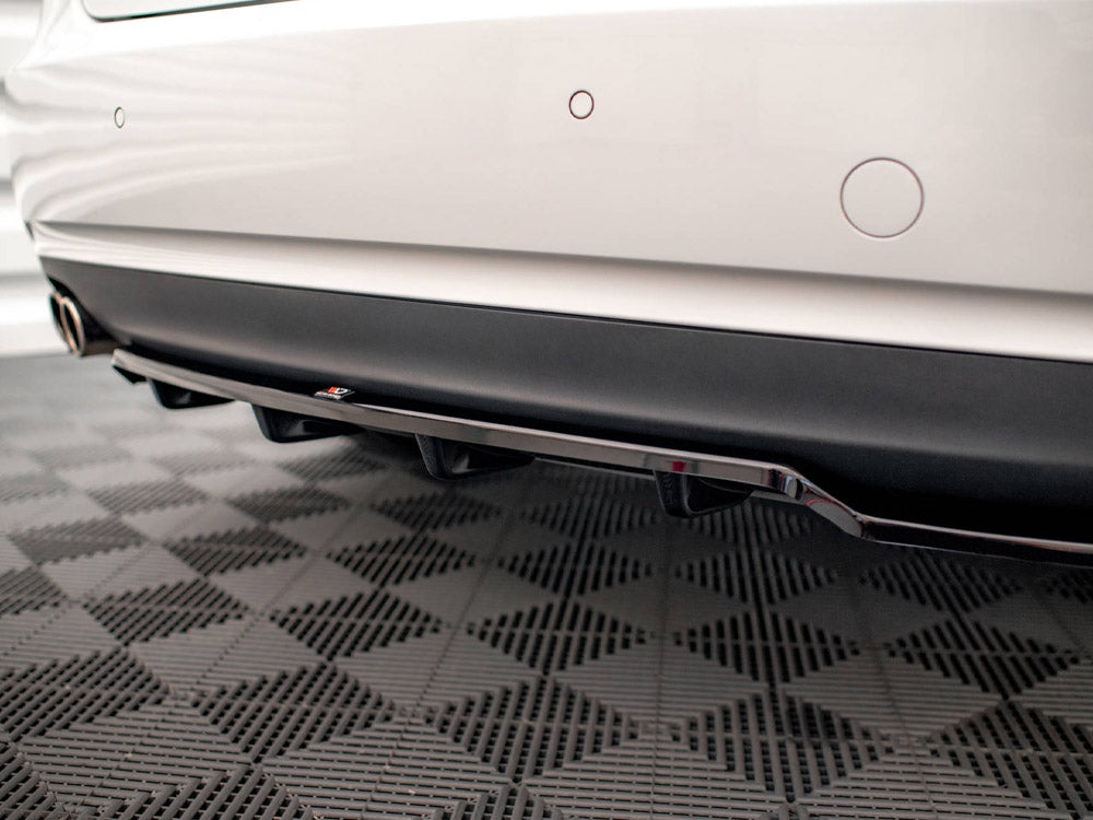 The rear of a white car with parking sensors is displayed, showcasing a black diffuser and exhaust pipes. It is situated on a checkered-patterned floor.