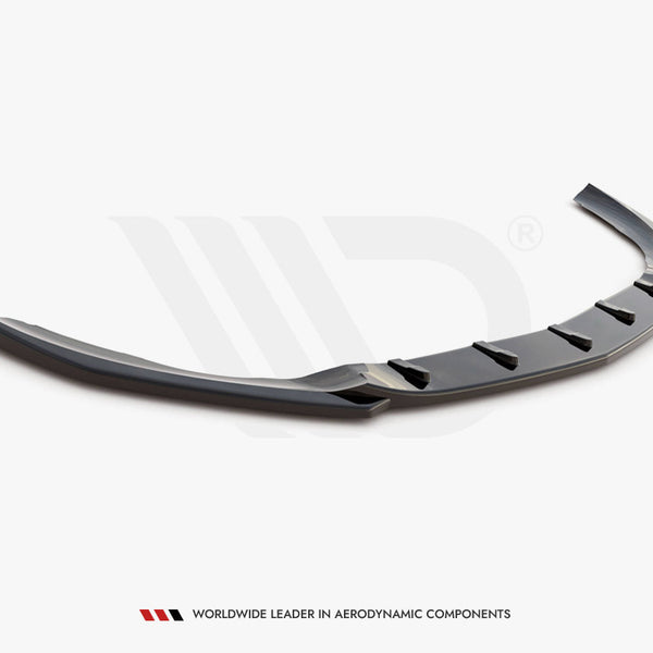 A glossy black car spoiler, featuring angular fins, rests on a plain white background. Text at the bottom reads, "WORLDWIDE LEADER IN AERODYNAMIC COMPONENTS."
