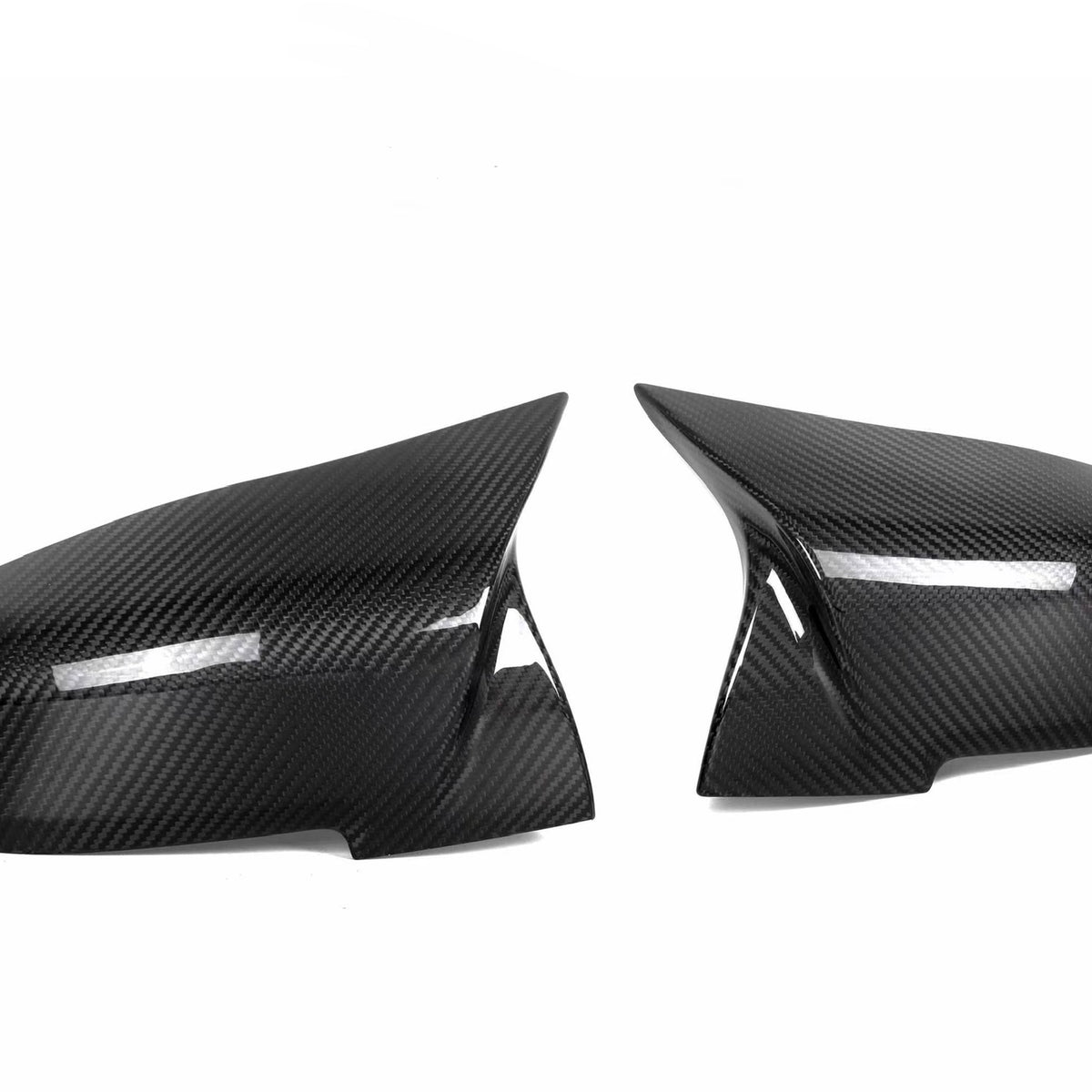 Two black carbon fiber car side mirror covers are positioned against a plain white background, showcasing their glossy, textured surface and sleek, aerodynamic shape.