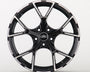 A sleek black alloy wheel with a glossy finish and five split spokes, featuring the Audi logo in the center, displayed against a plain white background.