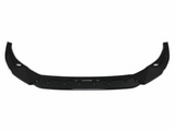A black car front lip spoiler, featuring an angular, aerodynamic design, lies against a plain white background, emphasizing its sleek structure.