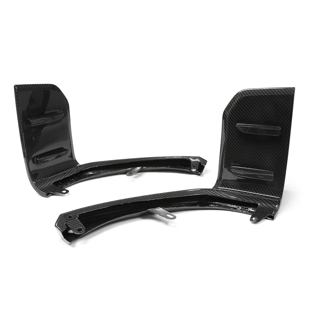 Two black carbon fiber car components are displayed on a white background, featuring curved structures with flat sections, likely designed for aerodynamic purposes.