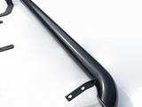 A sleek, black, curved metal bar with bracket mounts is positioned diagonally on a white surface. Additional small metal components are scattered nearby, suggesting assembly parts.