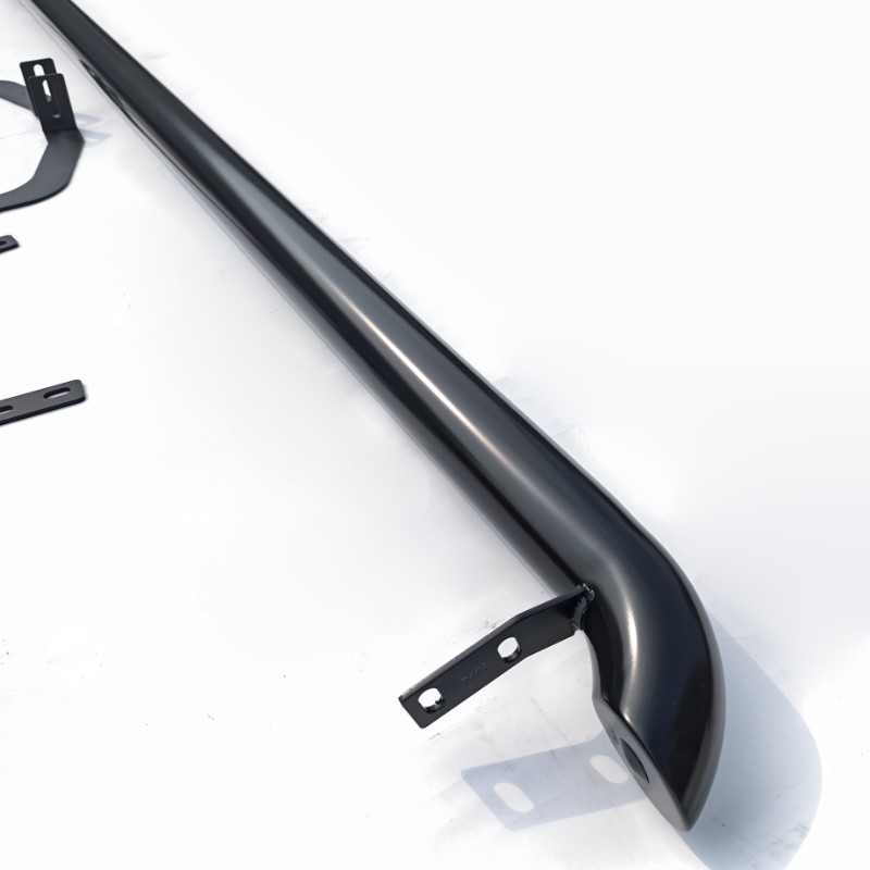 A sleek, black, curved metal bar with bracket mounts is positioned diagonally on a white surface. Additional small metal components are scattered nearby, suggesting assembly parts.