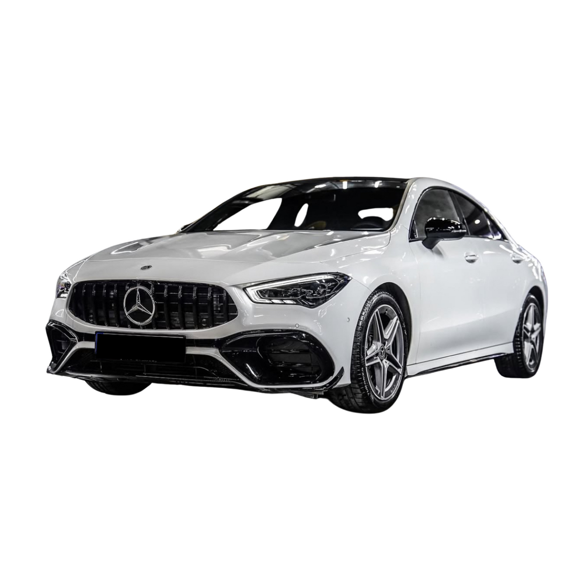 A white Mercedes sedan with a sleek design and star emblem grille is parked, showcasing its modern styling and five-spoke alloy wheels against a plain white background.