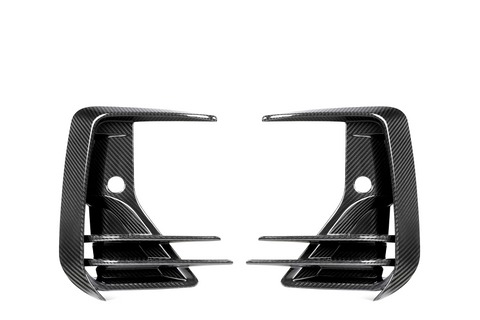 Two carbon fiber air vents, mirror each other, featuring three horizontal slats and a rounded hole in the center against a white background.