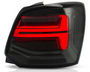 A rectangular car tail light with illuminated red sections is positioned against a white background, highlighting its sleek, modern design and layered contours.