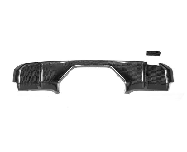 A carbon fiber car diffuser with a sleek, angular design, sits on a plain white background, paired with a small matching accessory piece above it.