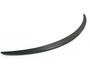 A sleek, black, curved car spoiler rests on a plain white background, highlighting its streamlined design and subtle texture.