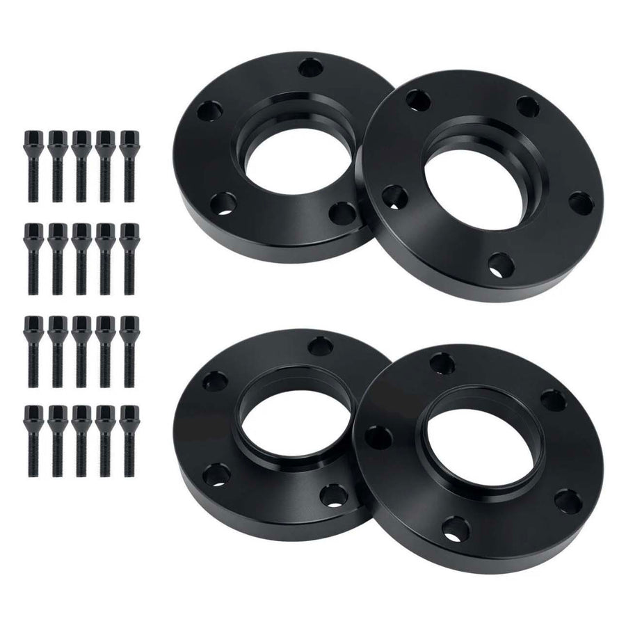 Four black circular metal spacers with holes alongside sixteen matching bolts, arranged on a plain white background, likely for automotive wheel fitting or adjustment.