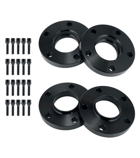 Four black circular metal spacers with holes alongside sixteen matching bolts, arranged on a plain white background, likely for automotive wheel fitting or adjustment.