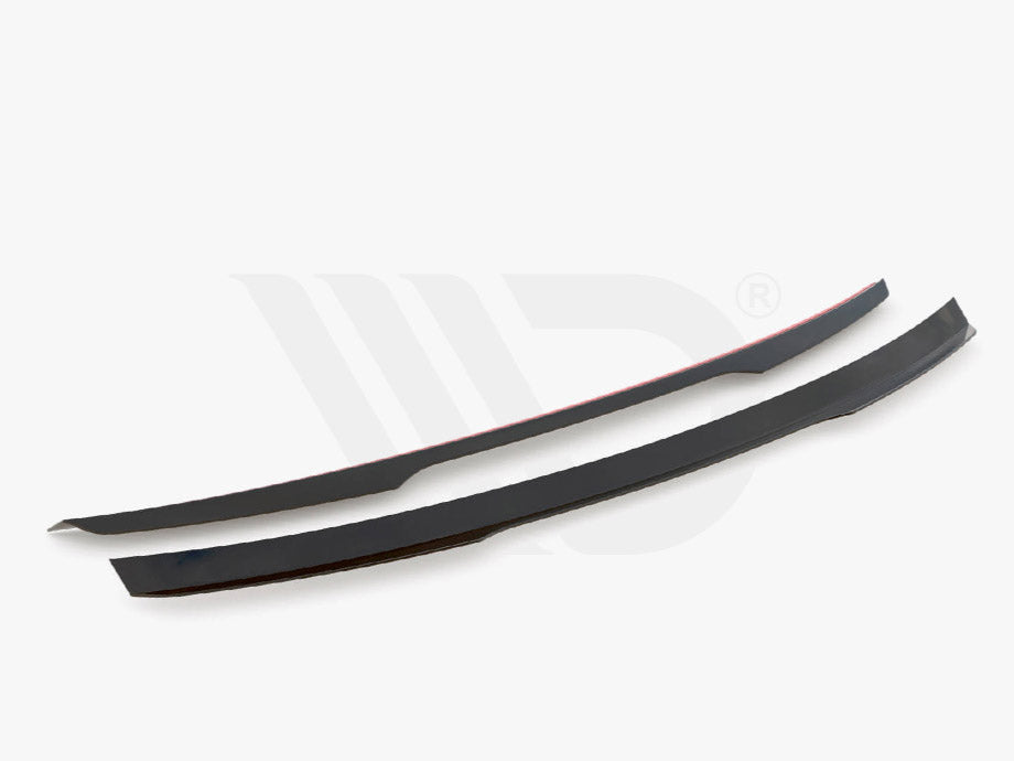 Two sleek, curved black car spoilers placed parallel on a plain white background. Text below reads: "Worldwide Leader in Aerodynamic Components."