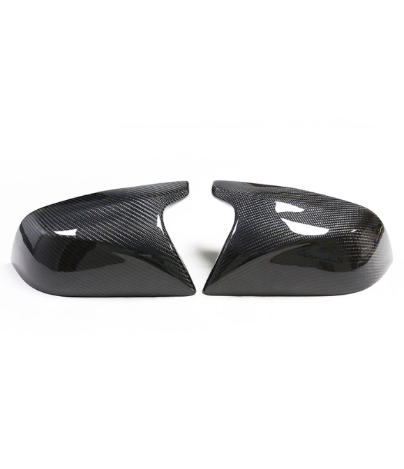 Two carbon fiber car mirror covers rest side by side on a white background, showcasing their glossy, patterned surface and aerodynamic design.