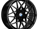 Black alloy wheel with a multi-spoke design, featuring a BMW logo at the center, standing against a white background.