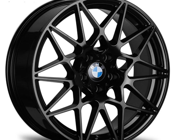 A black, multi-spoke wheel with a "BMW" logo is shown in a plain, white background, highlighting its intricate design and sleek finish.