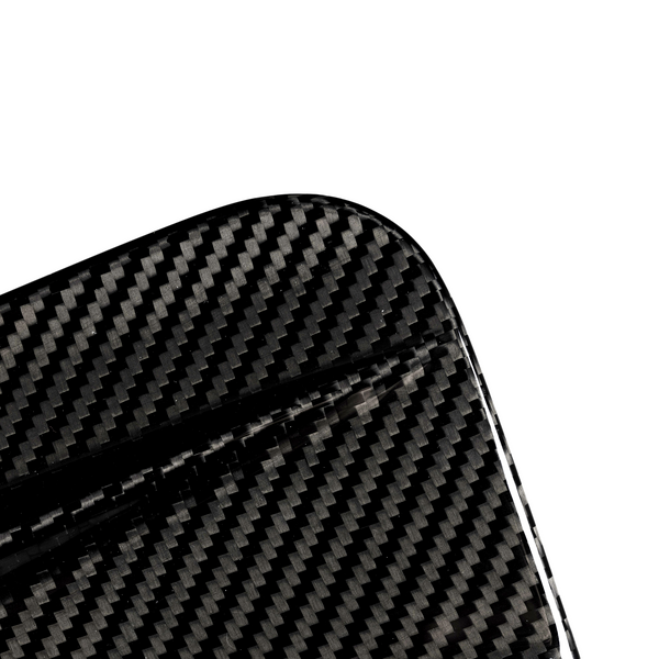 A close-up of a carbon fiber object with a visible textured pattern, featuring a rounded corner, set against a plain white background.