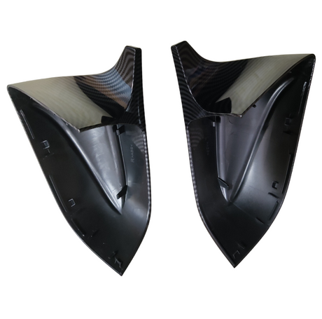 Two black carbon fiber car mirror caps, shaped to fit side mirrors, with textured surfaces, are displayed side by side against a plain white background. Text reads “RABSX.”