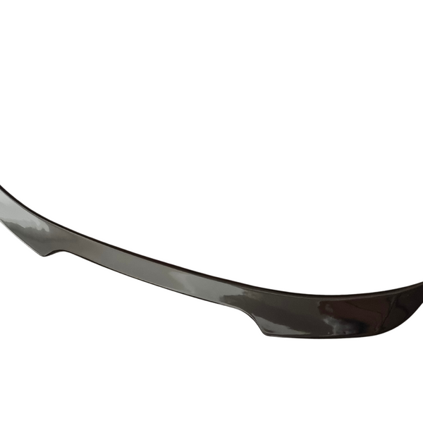 A sleek car spoiler, curved upward at the ends, appears against a plain white background, highlighting its aerodynamic design.