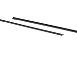 Two sleek black linear components lie parallel; segmented with grooves, likely parts for assembly or structural support, positioned on a plain white background.