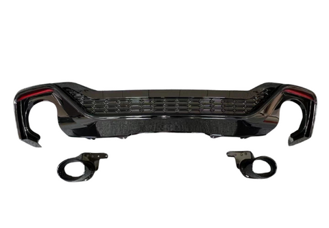 A glossy black car bumper with honeycomb grille design is displayed against a white background, accompanied by two matching circular pieces positioned below it.