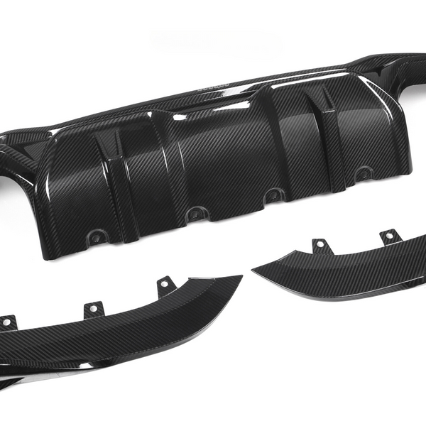 A glossy black carbon fiber car diffuser rests on a plain white background, consisting of one large central piece and two smaller side components with visible bolt holes.