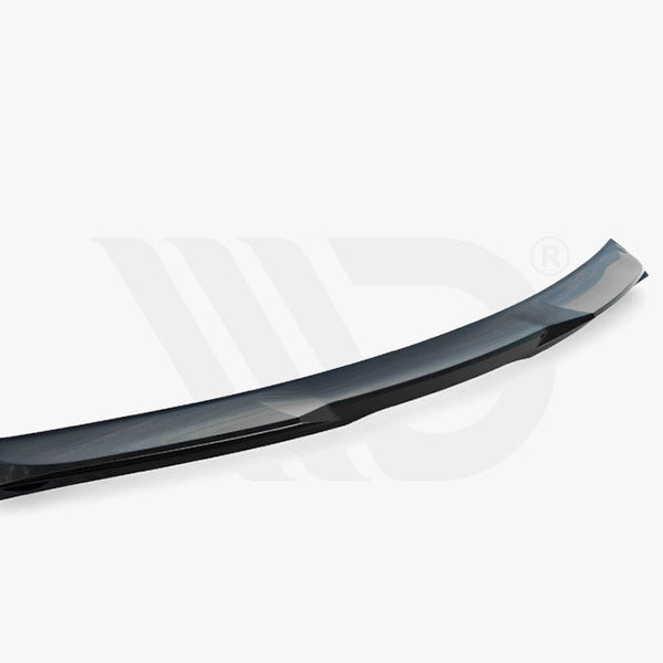 A black aerodynamic car spoiler, curved and streamlined, lies on a plain white background. Text below reads: "WORLDWIDE LEADER IN AERODYNAMIC COMPONENTS."