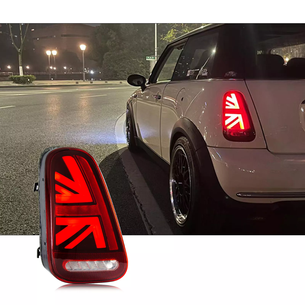 A car features distinctive red taillights resembling a national flag at night on a city street. A close-up inset of the taillight design is displayed in the foreground.