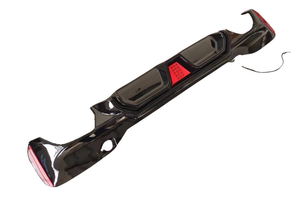 A sleek black car bumper features integrated red reflectors, positioned against a plain white background.