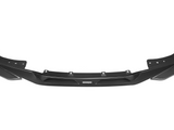 A black carbon fiber car front splitter features aerodynamic lines and mounting holes. The text 