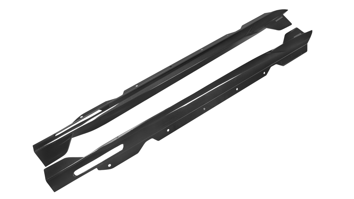 Two elongated, curved carbon-fiber automotive side skirts with mounting holes are laid side by side against a plain white background.