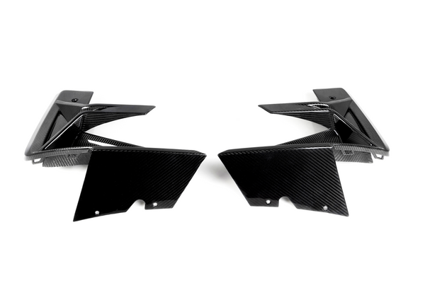 Two black carbon fiber car parts face each other, showcasing sleek, angular designs on a plain white background.