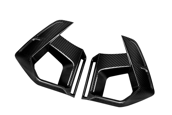 Two angular, carbon fiber car air vents, placed opposite each other, against a plain white background; their sleek, textured surfaces highlighting a modern, aerodynamic design.