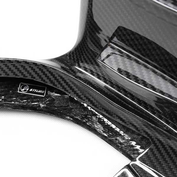 Carbon fiber material with "CT STYLING" label, showing glossy, textured surface. The item appears to be a component or cover, likely automotive, with visible weave pattern in a studio setting.